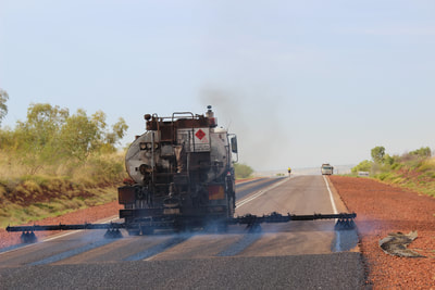 Our sprayer on the Stuart Highway doing what is known as a 'fog spray', applying extra bitumen to the non-trafficked areas of the road..